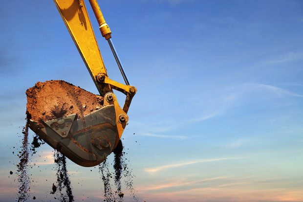 Excavator lifting dirt.